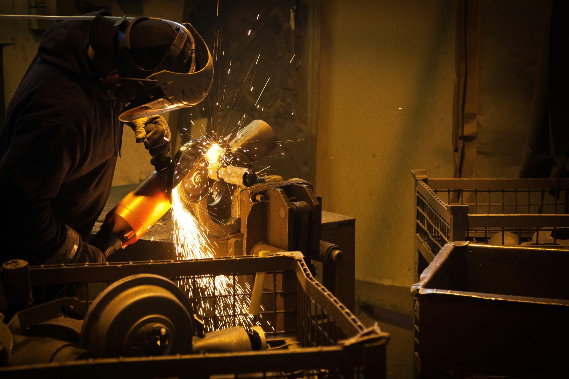 person grinding metal